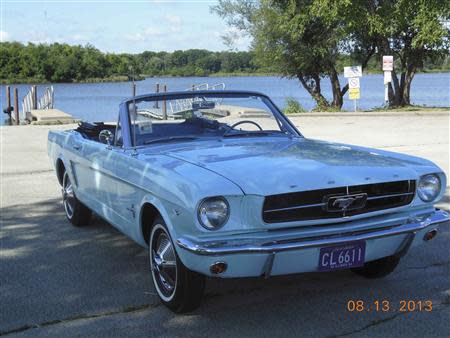 Gail Wise's Skylight Blue 1964 1/2 Ford Mustang convertible is parked during an outing in Chicago, Illinois August 13, 2013. Gail Wise, then using her maiden name of Gail Brown, made the first known retail purchase of a Mustang on April 15, 1964, two days before the model went on sale. Ford will unveil its next-generation 2015 Mustang on December 5, 2013 for the model's 50th anniversary with simultaneous events in Michigan, Shanghai, Sydney, Barcelona, New York and Los Angeles. REUTERS/Courtesy of Tom and Gail Wise/Handout via Reuters