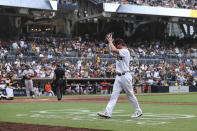 San Diego Padres' Wil Myers, foreground, claps his hands after being removed in the eighth inning of a baseball game against the San Francisco Giants, Wednesday, Oct. 5, 2022, in San Diego. (AP Photo/Derrick Tuskan)