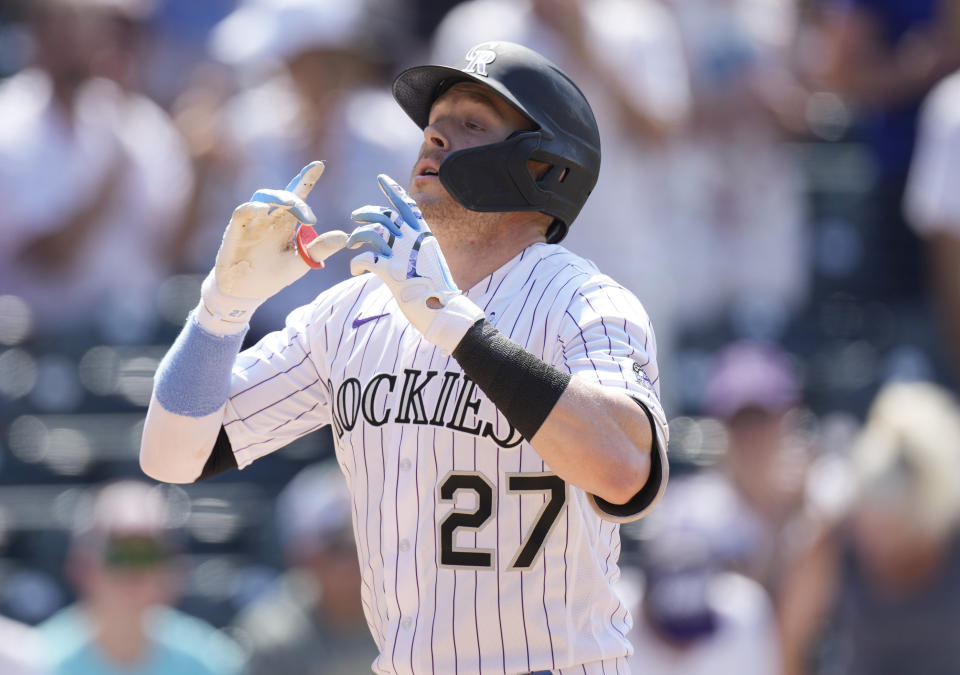 Colorado Rockies' Trevor Story gestures as he crosses home plate after hitting a solo home run off Milwaukee Brewers starting pitcher Eric Lauer in the sixth inning of a baseball game Sunday, June 20, 2021, in Denver. (AP Photo/David Zalubowski)