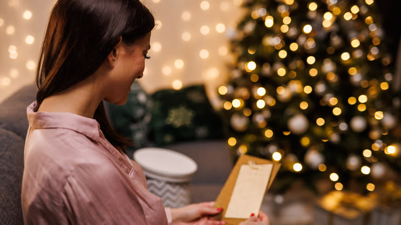 Person reading letter beside Christmas time