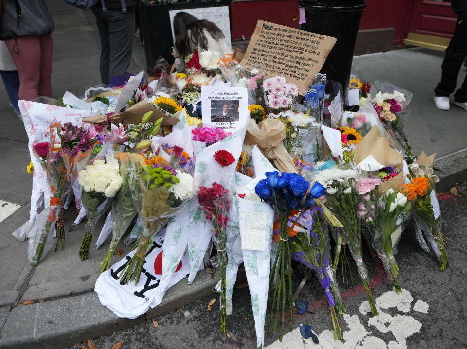 A makeshift memorial for Matthew Perry is seen outside the building shown in exterior shots of the television show "Friends" on Monday, Oct. 30, 2023, in New York. Perry, who played Chandler Bing on NBC's "Friends" for 10 seasons, was found dead at his Los Angeles home on Saturday. He was 54. (Photo by Charles Sykes/Invision/AP)