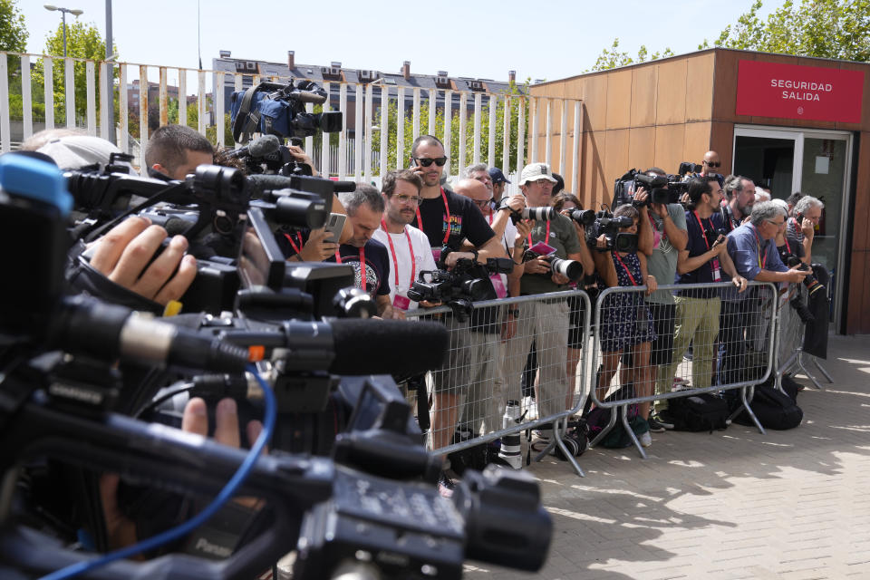 Photographers and TV camera operators wait to capture an image of Spanish Federation president Luis Rubiales after they were told to leave the Federation building in Las Rozas on the outskirts of Spain, Friday, Aug. 25, 2023. Rubiales has refused to resign despite an uproar for kissing a player, Jennifer Hermoso on the lips without her consent after the Women's World Cup final. Rubiales had also grabbed his crotch in a lewd victory gesture from the section of dignitaries with Spain's Queen Letizia and the 16-year old Princess Sofía nearby. (AP Photo/Paul White)