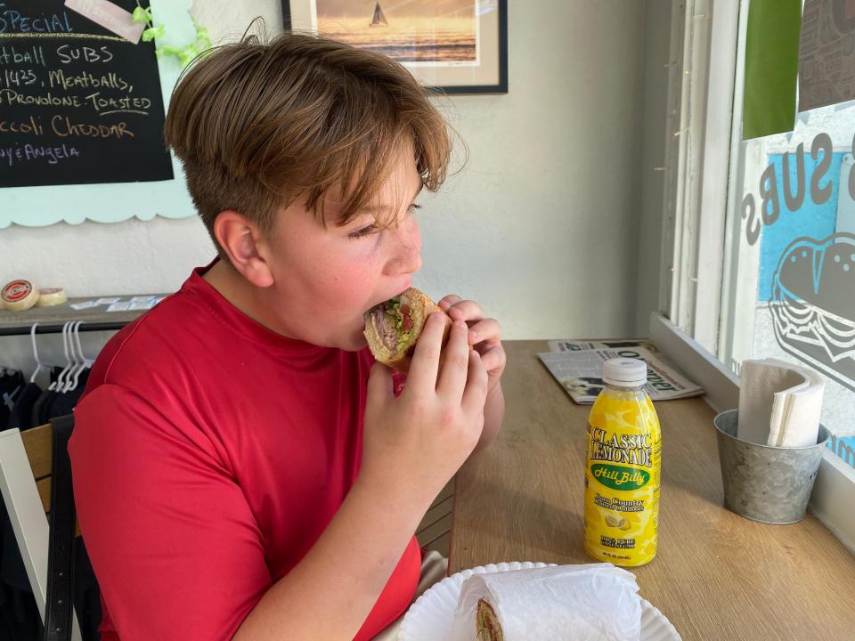 Jameson Lordi enjoys the Lake Quirky Club served at L-Dub Subs in downtown Lake Worth Beach.