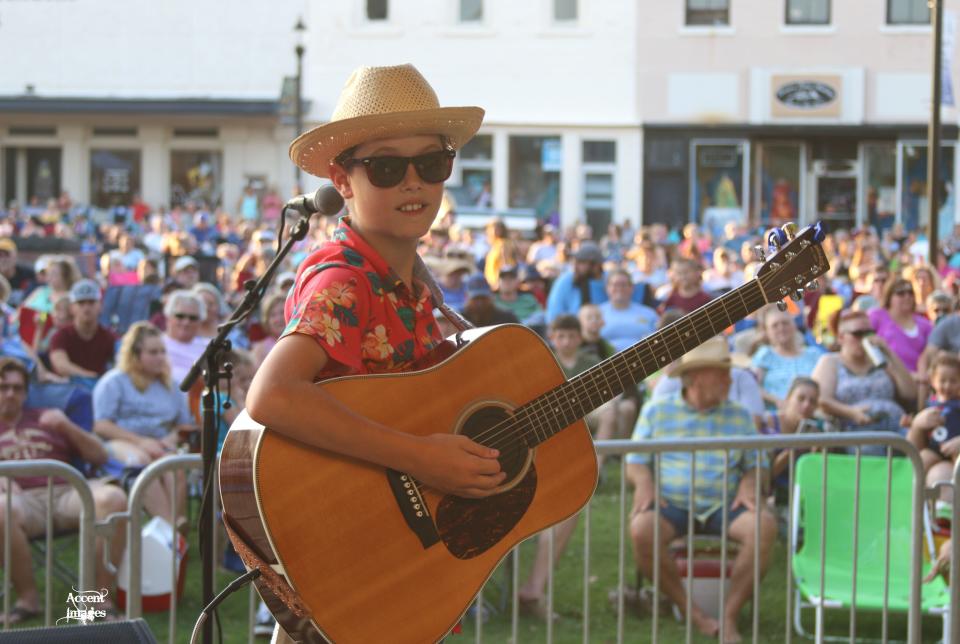 Sawyer Guymon entertains a crowd of concert goers during the 2019 Music on Main concert series. The city of Denison was declared a music-friendly community by Gov. Greg Abbott Tuesday morning.