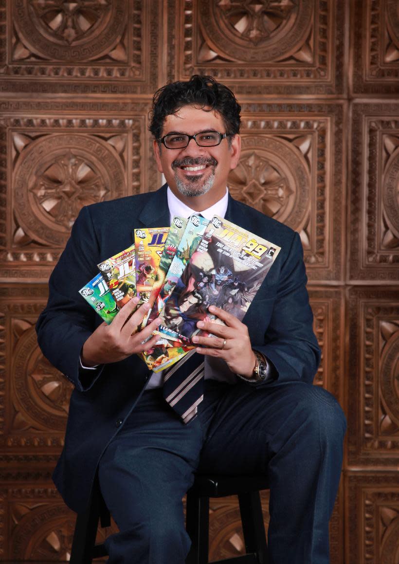 In this image released by Teshkeel Media Group, comic book author Naif Al-Mutawa holds up copies of his comic book series "The 99," on Long Island, N.Y. (AP Photo/Teshkeel Media Group, Cara Hromada Photography)