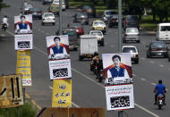 Posters with images of Imran Khan are displayed in the celebration of his government at a highway in Islamabad, Pakistan, Saturday, Aug. 18, 2018. Pakistan's cricket star-turned-politician Khan was sworn in as prime minister on Saturday despite protests by opposition parties, which accuse the security services of intervening on his behalf in last month's elections. The poster reads 'Welcome to this new government with new hopes and aspiration'. (AP Photo/Anjum Naveed)