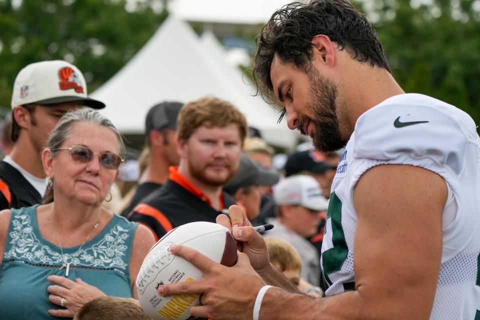 Green Bay Packers long snapper Matt Orzech (42) autographs a football for a fan after a joint practice between the Green Bay Packers and the Cincinnati Bengals, Wednesday, Aug. 9, 2023, at the practice fields next to Paycor Stadium in Cincinnati.