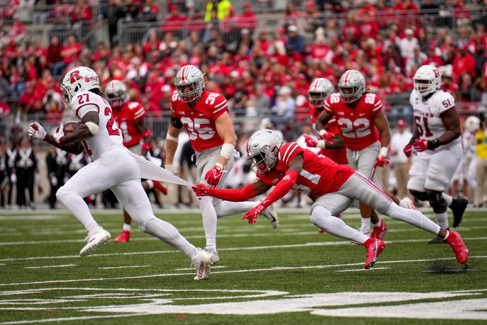 Oct 1, 2022; Columbus, Ohio, USA; Rutgers Scarlet Knights running back Samuel Brown V (27) dodges a tackle attempt by Ohio State Buckeyes safety Kye Stokes (37) during the second quarter of the NCAA Division I football game between the Ohio State Buckeyes and the Rutgers Scarlet Knights at Ohio Stadium. Mandatory Credit: Joseph Scheller-The Columbus Dispatch