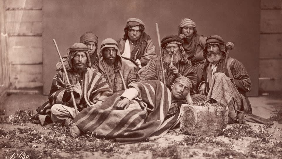 Historians trace the history of the keffiyeh to nomadic Bedouin farmers in historic Palestine, who use the scarves as protection from the sun and sand. - Bettmann Archive/Getty Images