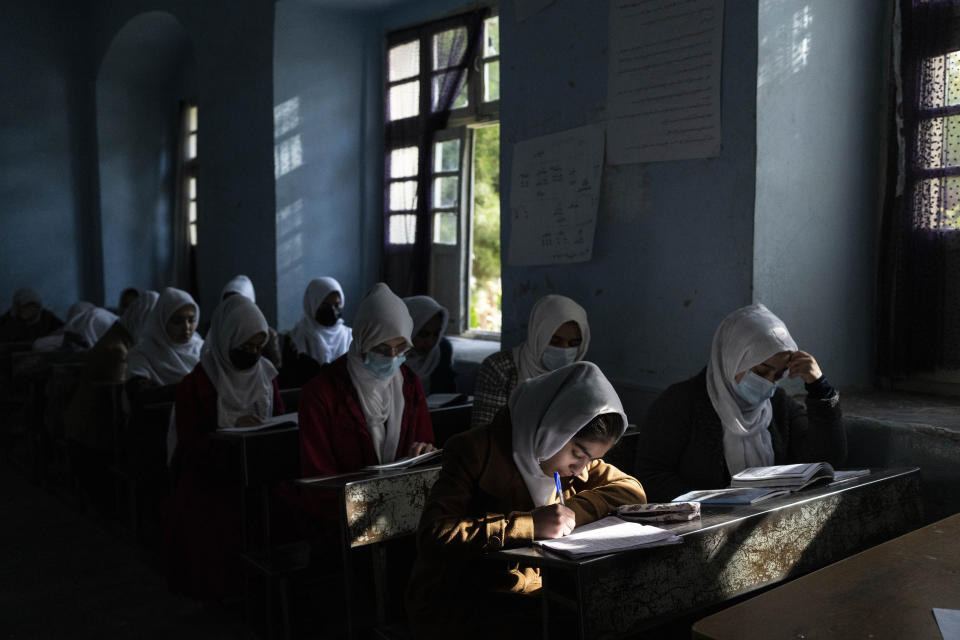 Afghan girls participate a lesson at Tajrobawai Girls High School, in Herat, Afghanistan, Thursday, Nov. 25, 2021. While most high school girls in Afghanistan are forbidden to attend class by the country's Taliban rulers, one major exception are those in the western province of Herat. For weeks, girls there have been attending high school classes, thanks to a unique effort by teachers and parents to persuade local Taliban administrators to allow schools to reopen. (AP Photo/Petros Giannakouris)