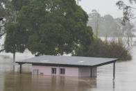 A building is inundated with water at Richmond on the outskirts of Sydney, Australia, Tuesday, July 5, 2022. Hundreds of homes have been inundated in and around Australia’s largest city in a flood emergency that was threatening 50,000 people, officials said on Tuesday. (AP Photo/Mark Baker)