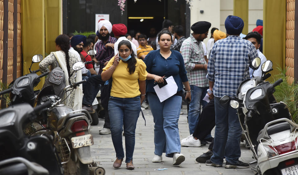 Candidates leave after appearing for an International English Language Testing System (IELTS) examination in Amritsar, India, July 9, 2022. Many Indians are opting to go abroad for "better prospects" as raging unemployment is worsening insecurity and inequality between the rich and poor in Asia's third largest economy. (AP Photo/Prabhjot Gill)