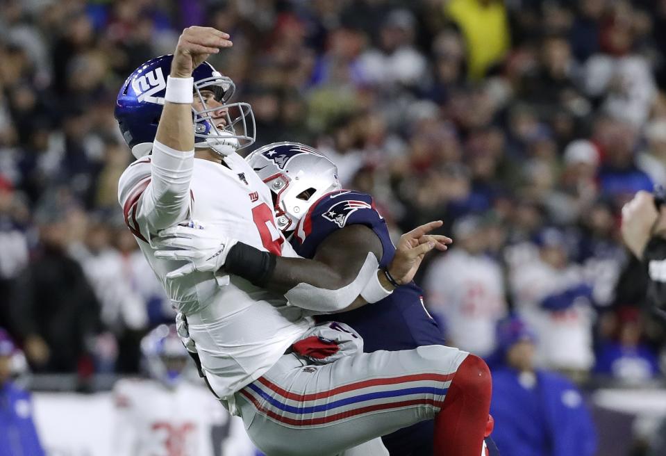 New England Patriots linebacker Ja'Whaun Bentley, right, hits New York Giants quarterback Daniel Jones after he released a pass in the second half of an NFL football game, Thursday, Oct. 10, 2019, in Foxborough, Mass. (AP Photo/Elise Amendola)