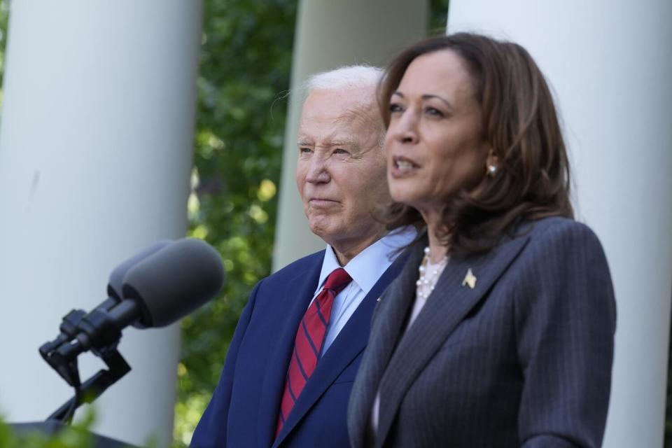 President Biden listens as Vice President Kamala Harris speaks.