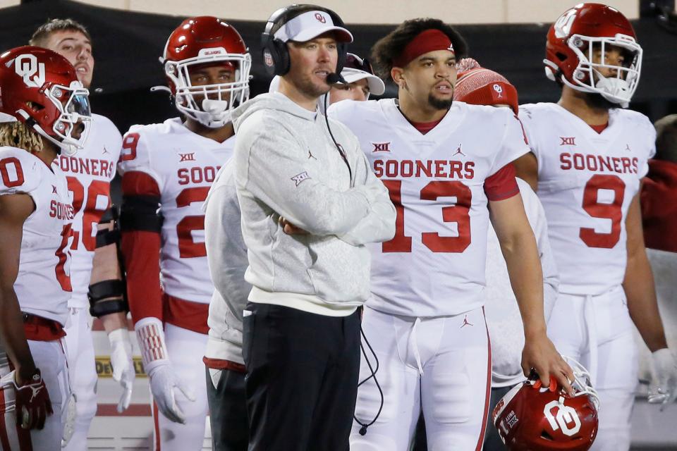 OU coach Lincoln Riley talks with quarterback Caleb Williams (13) during a 37-33 loss at OSU on Saturday.