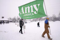 Volunteers Tim Schumann, left, and Chase Cushman move an "Amy for America" sign into place Sunday, Feb. 10, 2019, prior to Democratic Sen. Amy Klobuchar's announcement of her decision in the race for president at a rally in Minneapolis. (Anthony Souffle/Star Tribune via AP)