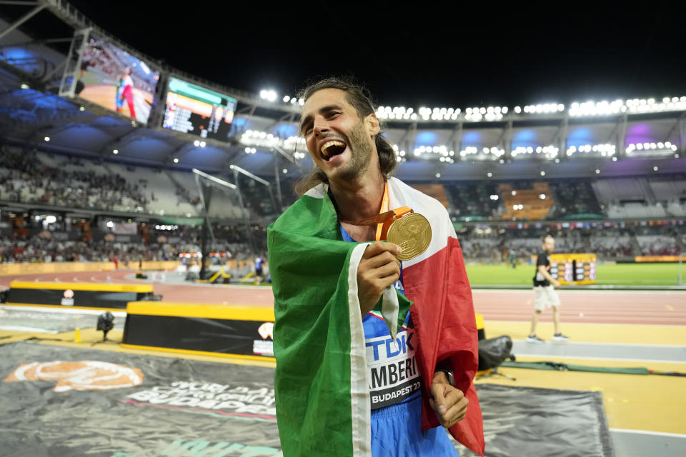 Gianmarco Tamberi, of Italy, celebrates after winning the gold medal in the Men's high jump final during the World Athletics Championships in Budapest, Hungary, Tuesday, Aug. 22, 2023. (AP Photo/Ashley Landis)