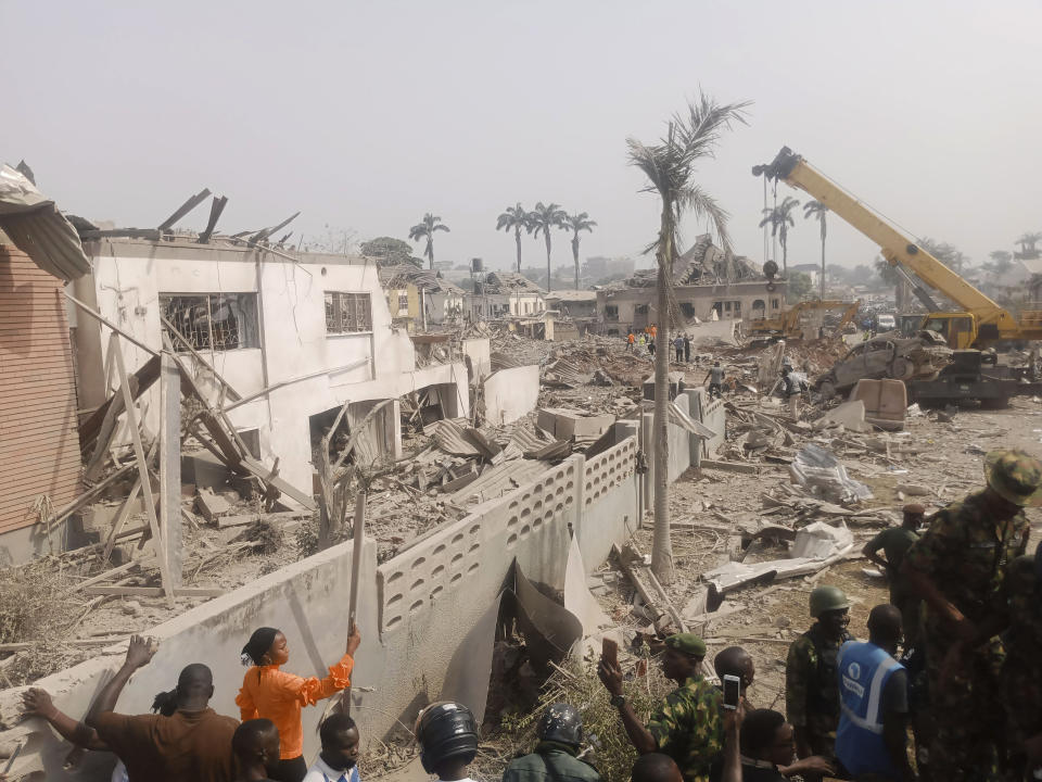 People gather at the site of an explosion in Ibadan, Nigeria, Wednesday, Jan. 17, 2024. Several people died and many others were injured after a massive blast caused by explosives rocked more than 20 buildings in one of Nigeria's largest cities Tuesday night, authorities said Wednesday, as rescue workers dug through the rubble in search of those feared trapped. (AP Photo)