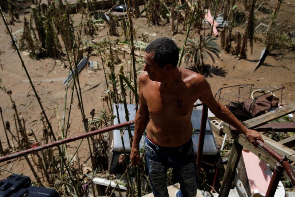 A man looks at the damage after his house was hit by Hurricane Maria in Toa Baja, Puerto Rico (REUTERS)