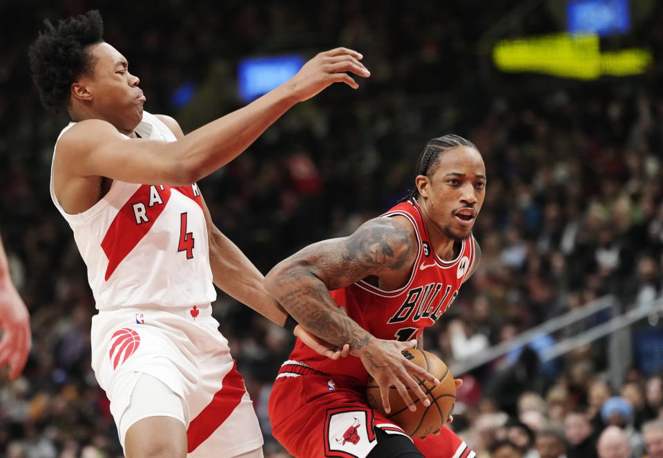 Chicago Bulls forward DeMar DeRozan (11) drives past Toronto Raptors forward Scottie Barnes (4) during the first half of an NBA basketball game Tuesday, Feb. 28, 2023, in Toronto. (Frank Gunn/The Canadian Press via AP)