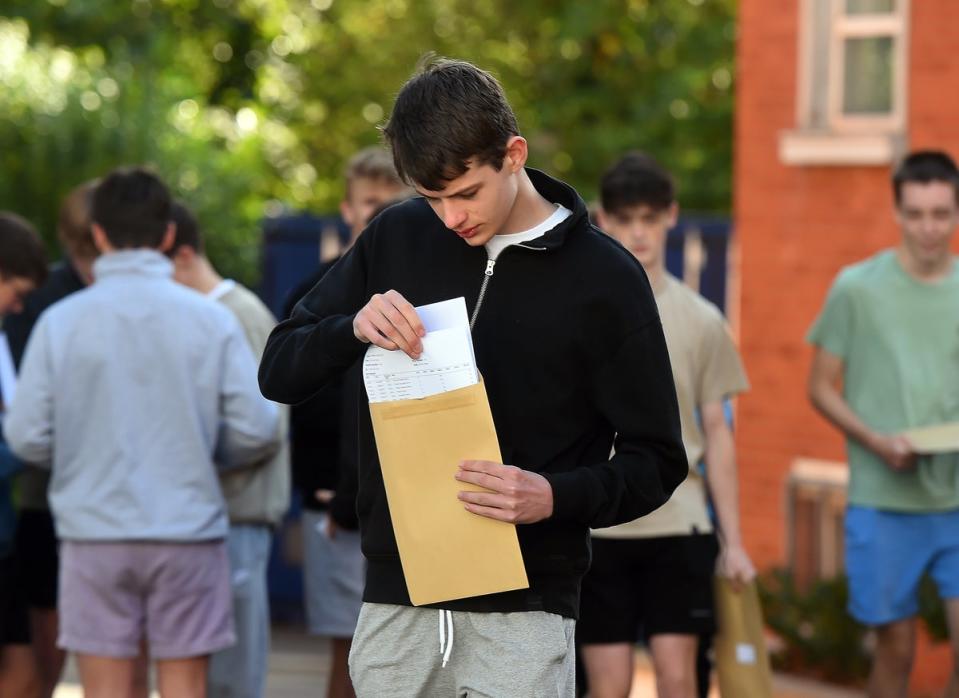 Pupils at Sullivan Upper School in Holywood, Co Down, check their results (Oliver McVeigh/PA) (PA Wire)