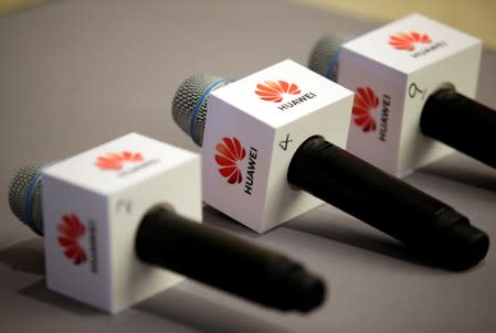 Microphones with Huawei logos are placed for a news conference at the headquarters in Shenzhen