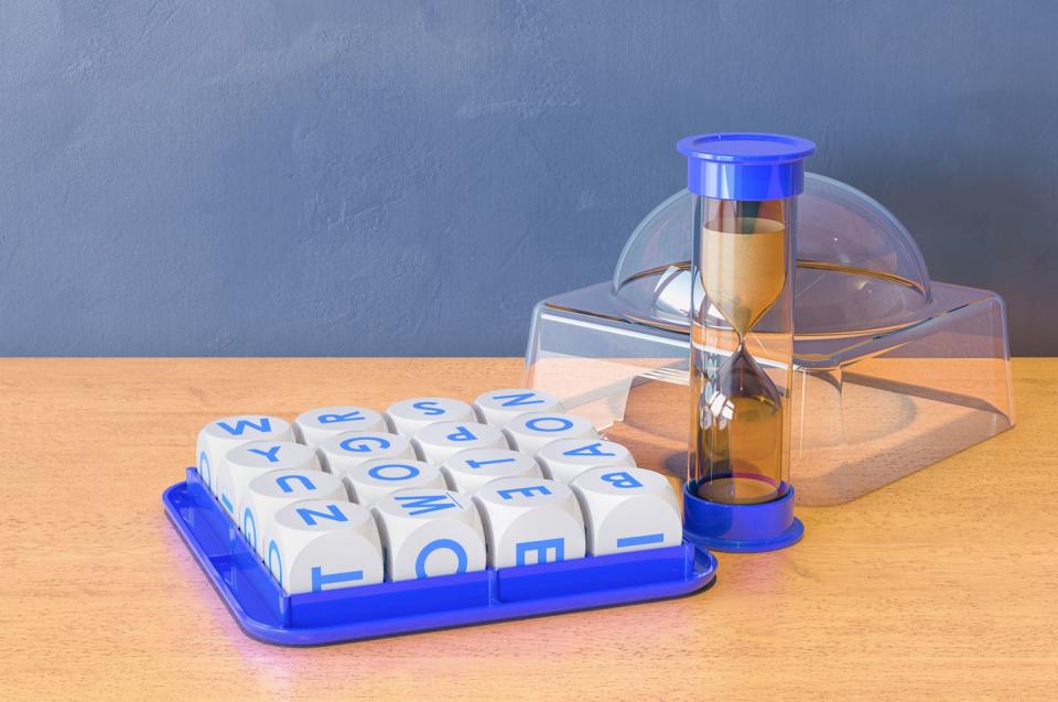 boggle board game on the wooden table 3d rendering