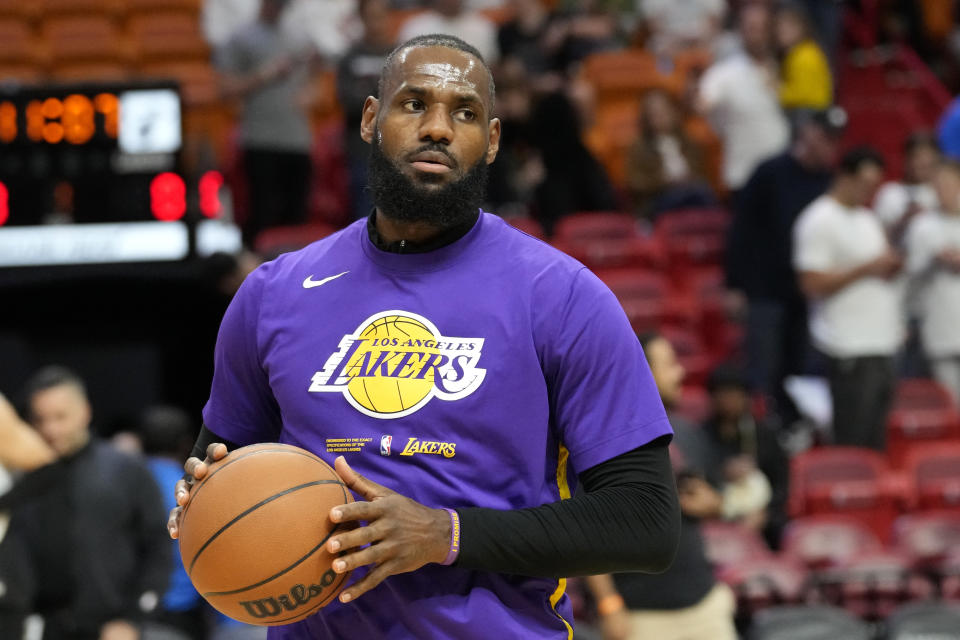 Los Angeles Lakers forward LeBron James warms up before an NBA basketball game against the Miami Heat, Wednesday, Dec. 28, 2022, in Miami. (AP Photo/Lynne Sladky)