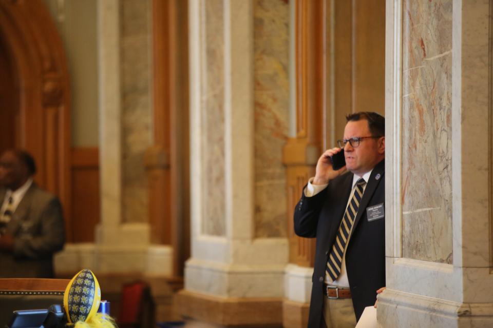 Rep. Jesse Borjon, R-Topeka, takes a phone call shortly before lawmakers vote to override Gov. Laura Kelly on Senate Bill 180 Thursday.
