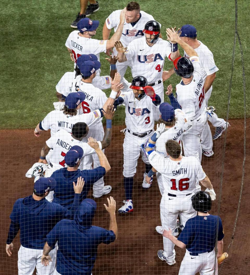 USA outfielder Mookie Betts (3) and infielder Paul Goldschmidt (46) celebrate with teammates after scoring two runs against Cuba during the first inning of a semifinal game at the World Baseball Classic at loanDepot Park on Sunday, March 19, 2023, in Miami, Fla.