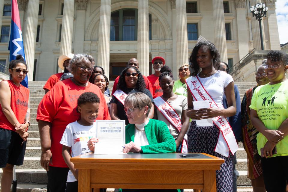 Gov. Laura Kelly, seen here signing a Juneteenth proclamation for the 2022 celebration, has made Juneteenth a holiday for state employees under her administration.