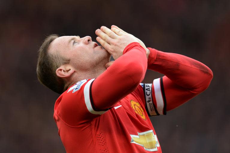 Manchester United's English striker Wayne Rooney celebrates scoring their second goal during the English Premier League football match between Manchester United and Aston Villa at Old Trafford in Manchester, North West England on April 4, 2015