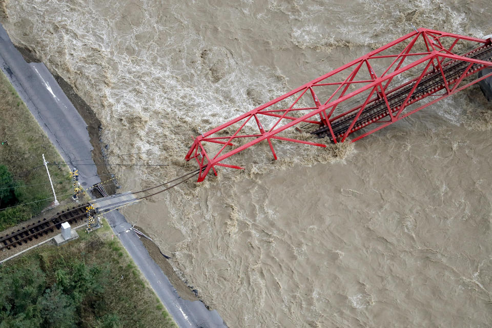 A collapsed railway bridge is seen over Chikuma river swollen by Typhoon Hagibis in Ueda, central Japan, October 13, 2019, in this photo taken by Kyodo. Mandatory credit Kyodo/via REUTERS ATTENTION EDITORS - THIS IMAGE WAS PROVIDED BY A THIRD PARTY. MANDATORY CREDIT. JAPAN OUT