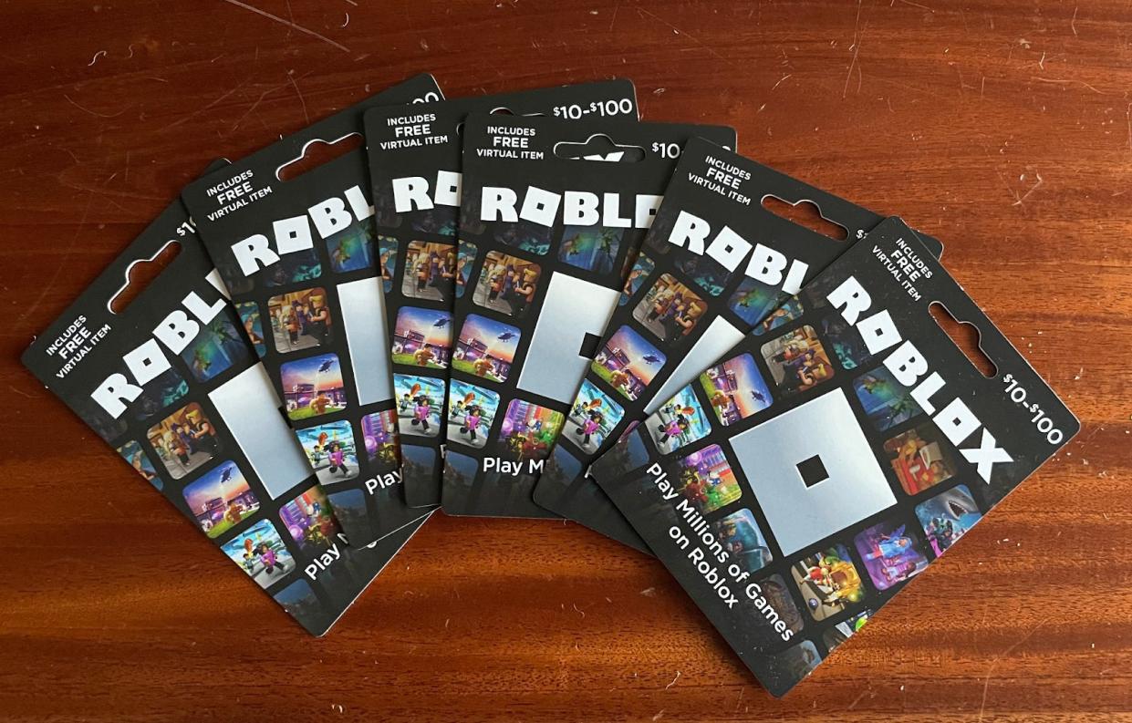 A pack of Roblox gift cards spread out on a table.