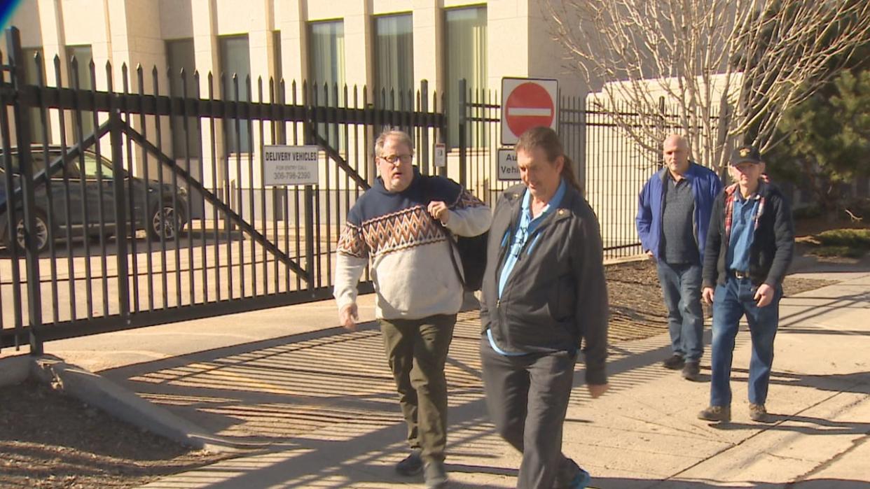 Michael Gordon Jackson, on the front left in a sweater, is charged with abduction. His trial is expected to take two weeks.  (Richard Agecoutay/CBC - image credit)