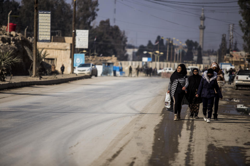 Civilians return to the city after fighting subsideds in Hassakeh, Syria, Sunday, Jan. 30, 2022. The Islamic State group's Jan. 20 attack on the prison in Hassakeh was the biggest military operation by the extremist group since the fall of their self-declared caliphate in 2019. (AP Photo/Baderkhan Ahmad)