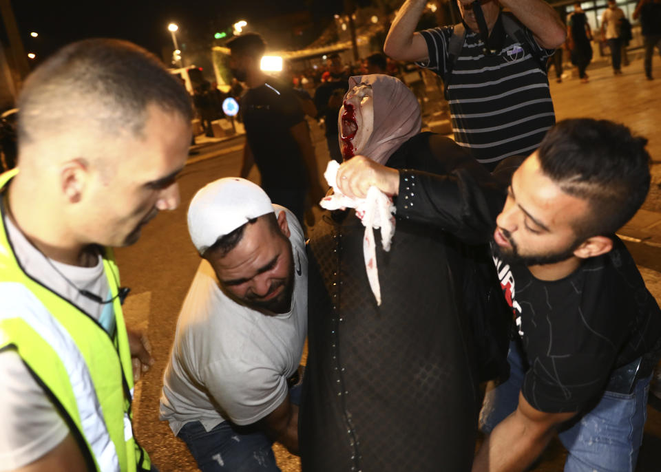 An injured Palestinian demonstrator is helped during clashes at Damascus Gate just outside Jerusalem's Old City, Saturday, May 8, 2021. (AP Photo/Oded Balilty)