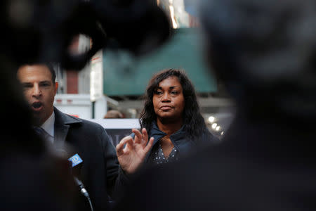 Tamara Lanier listens to attorney Josh Koskoff (L) speak to the media about a lawsuit accusing Harvard University of the monetization of photographic images of her great-great-great grandfather, an enslaved African man named Renty, and his daughter Delia, outside of the Harvard Club in New York, U.S., March 20, 2019. REUTERS/Lucas Jackson