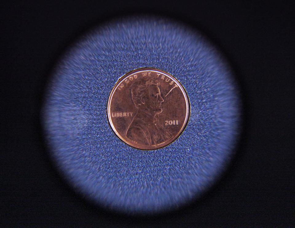 An error coin is displayed at the U.S. Mint on Wednesday, June 27, 2012, in Philadelphia. The new $3.9 million exhibit opens a new tour to visitors on July 3 and it's the first upgrade in more than 40 years.(AP Photo/Brynn Anderson)