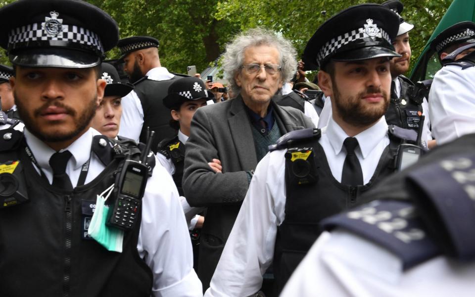 Piers Corbyn being lead away by police at a demonstration at Hyde Park earlier this year - PA