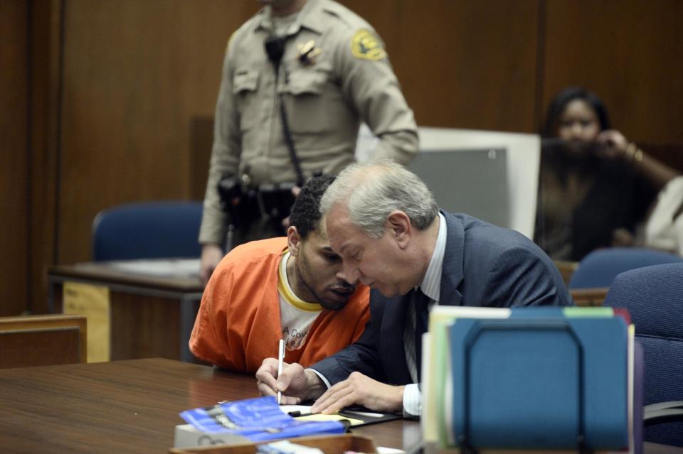 Chris Brown, left is shown in court with his attorney, Mark Geragos Friday May 9, 2014 in Los Angeles. Brown on Friday admitted a probation violation over an altercation last year outside a hotel in Washington, D.C., and was sentenced to remain on probation and serve an additional 131 days in jail. (AP Photo/Paul Buck, POOL)