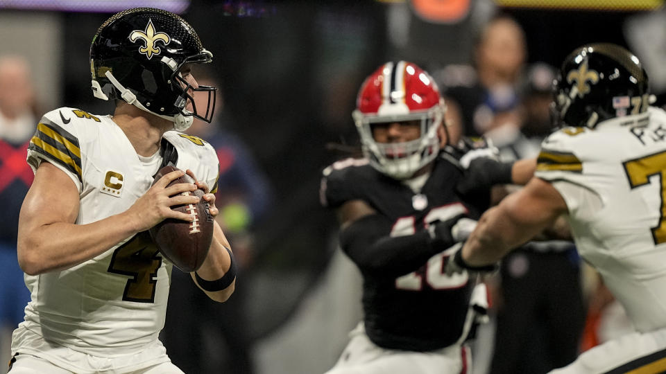 New Orleans Saints quarterback Derek Carr (4) looks to pass in the pocket against the Atlanta Falcons during the first half of an NFL football game, Sunday, Nov. 26, 2023, in Atlanta. (AP Photo/Brynn Anderson)