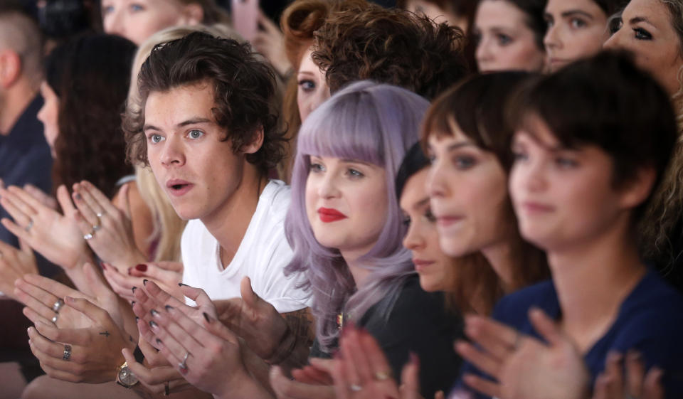 Harry Styles of the band One Direction (L), actress Kelly Osbourne (2nd L), model Leigh Lazark (C), television presenter Alexa Chung (2nd R) and model Pixie Geldof, daughter of musician Bob Geldof, applaud following the House of Holland Spring/Summer 2014 collection presentation during London Fashion Week September 14, 2013. REU TERS/Suzanne Plunkett (BRITAIN - Tags: FASHION ENTERTAINMENT)