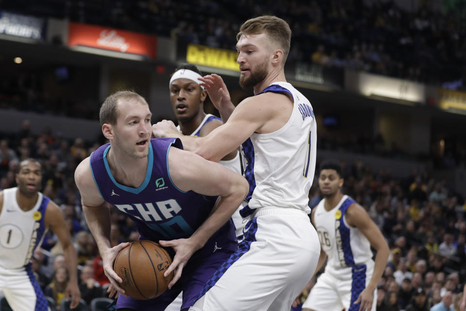 Charlotte Hornets' Cody Zeller (40) makes a pass against Indiana Pacers' Domantas Sabonis (11) during the first half of an NBA basketball game, Sunday, Dec. 15, 2019, in Indianapolis. (AP Photo/Darron Cummings)