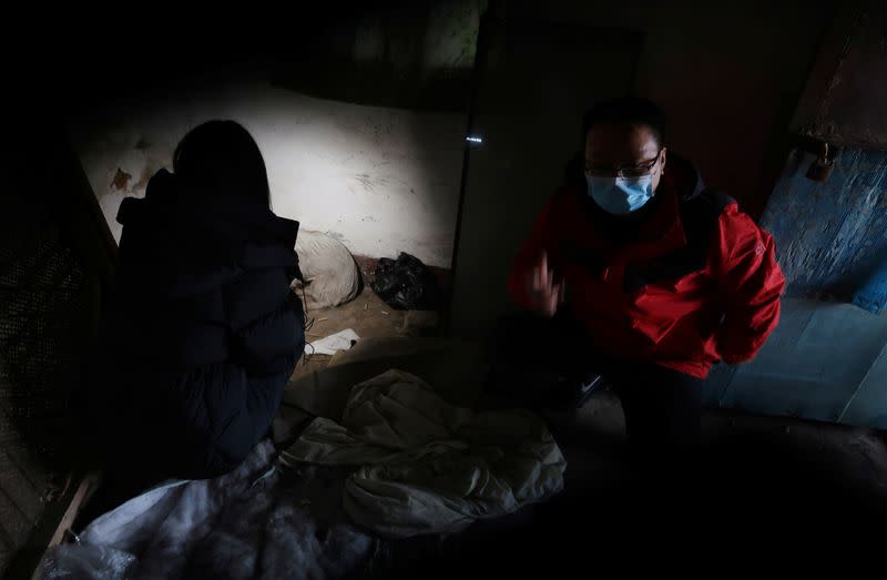 Du Fan looks on during the rescue of a stray dog in Wuhan