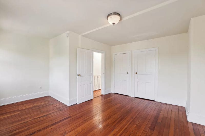 Empty beige bedroom with two closets