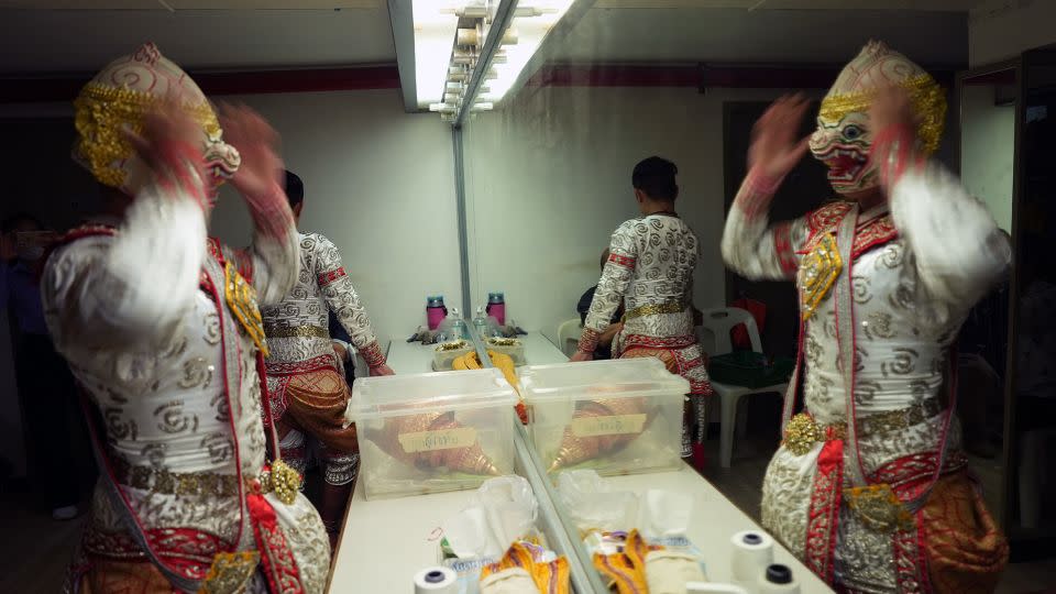 Thanet Pakwisath puts on his Hanuman mask prior to an afternoon show at Sala Charlermkrung, - Mark Phillips/CNN