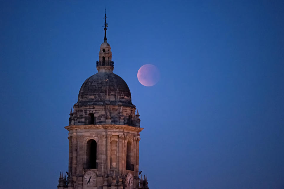 <p>The moon shone pink over Malaga, Spain. </p>