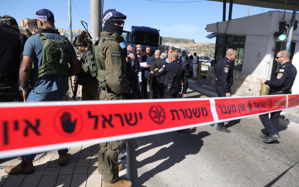 Israeli forces secure the site of a stabbing attack at the checkpoint