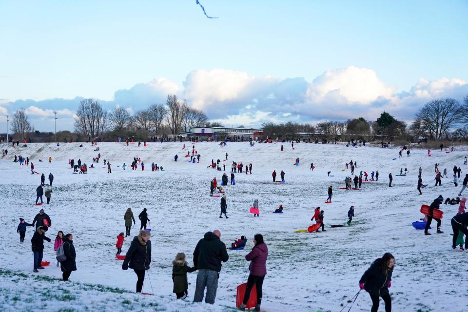 People sledging in a snow covered park in Whitley BayPA